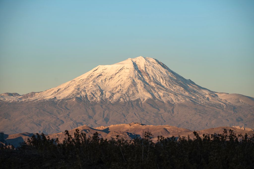 A stunning view of Mount Ararat with its snow-capped peak, seen from Karagüney, Iğdır, Turkey in the early morning light.