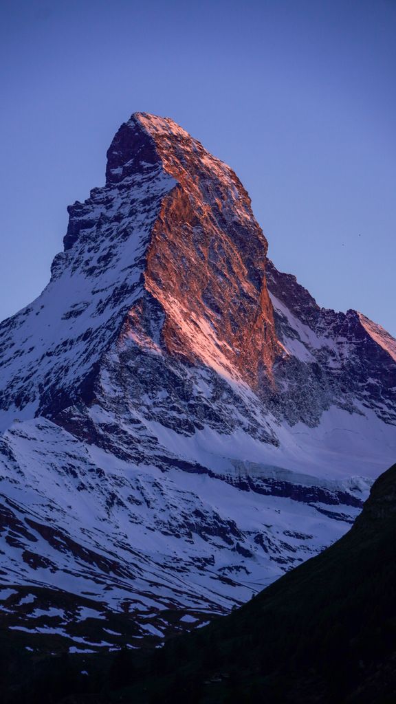 Breathtaking view of the Matterhorn, Zermatt, Switzerland, illuminated by the sunset glow.