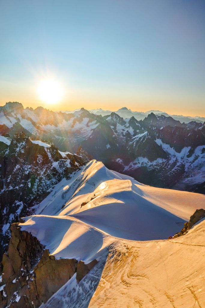 Majestic view of Chamonix-Mont-Blanc mountains at sunset, showcasing stunning snow-capped peaks.