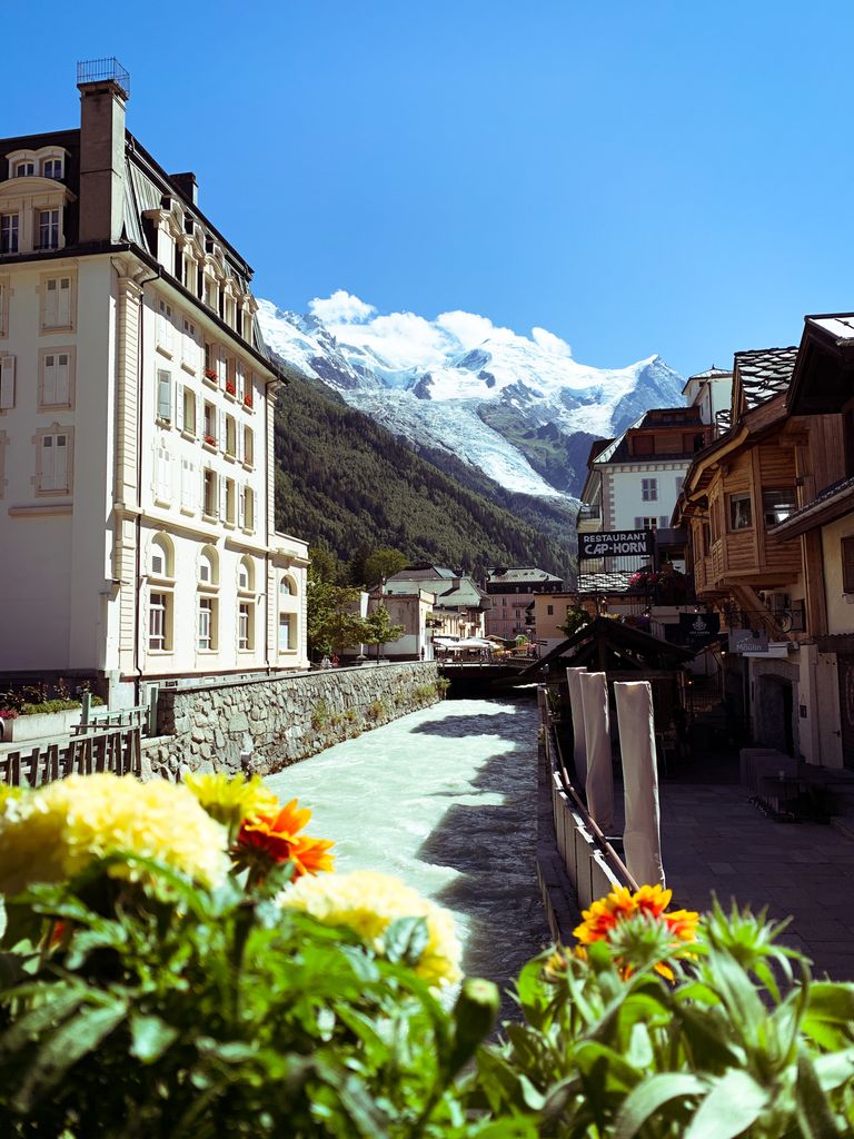 Scenic view of Chamonix town with Mont Blanc and a vibrant garden in the foreground.