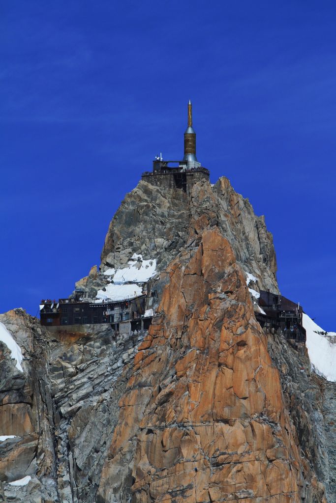 Stunning view of Aiguille du Midi summit in Chamonix-Mont-Blanc, captured under a clear blue sky.