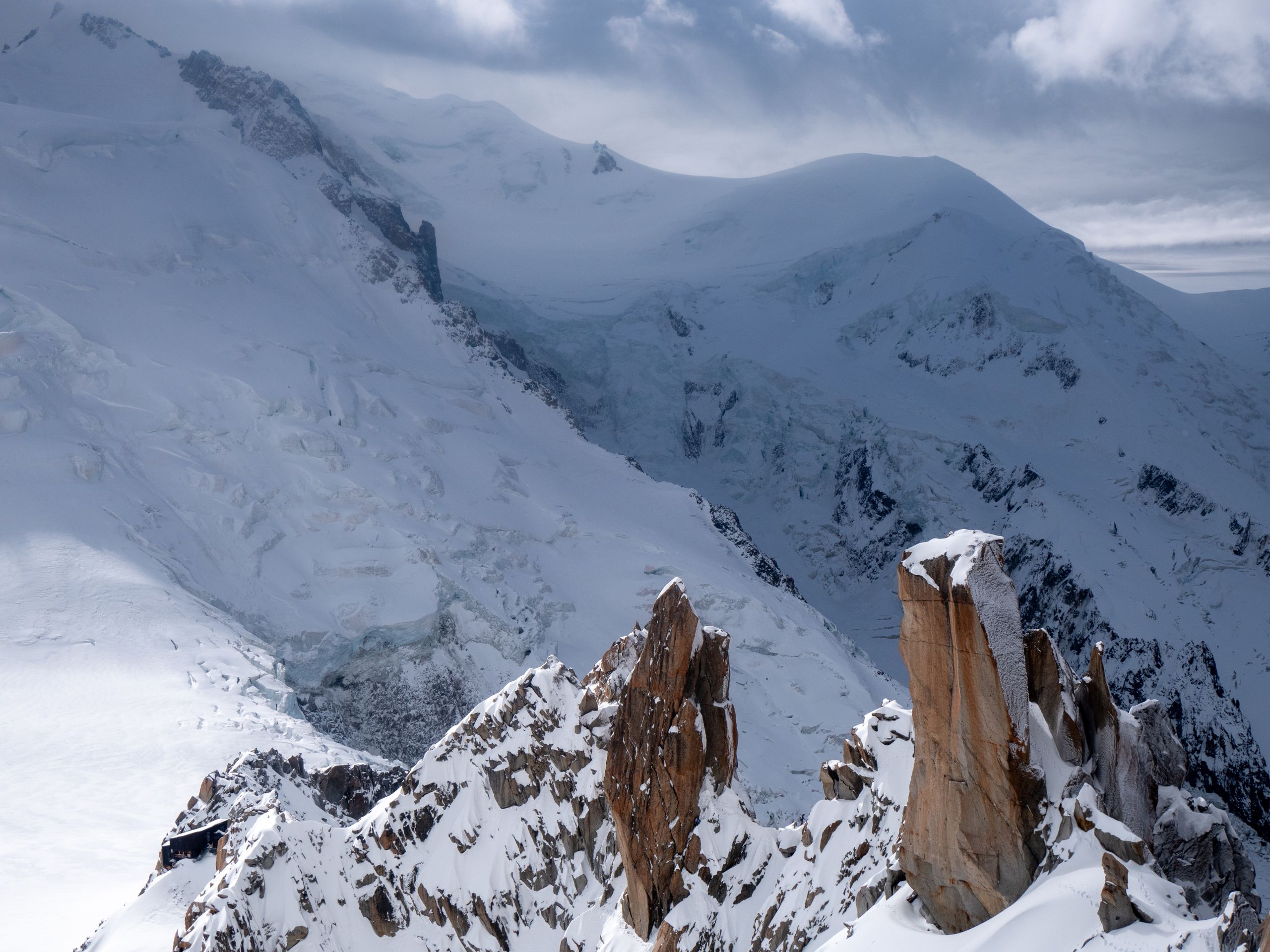 Stunning winter landscape of Mont Blanc in Chamonix-Mont-Blanc, showcasing snow-covered peaks under a blue sky.